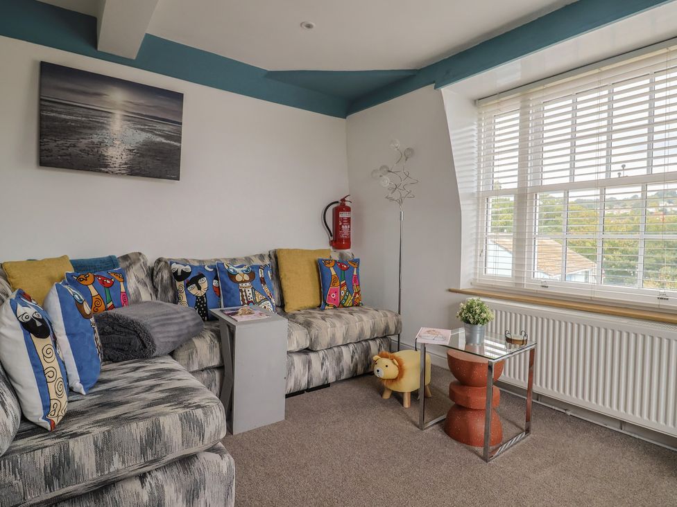 A living room with a sofa and coffee table at Jasper in Lyme Regis