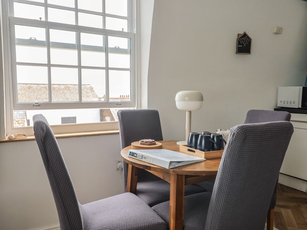A dining room with a table and chairs at Jasper in Lyme Regis