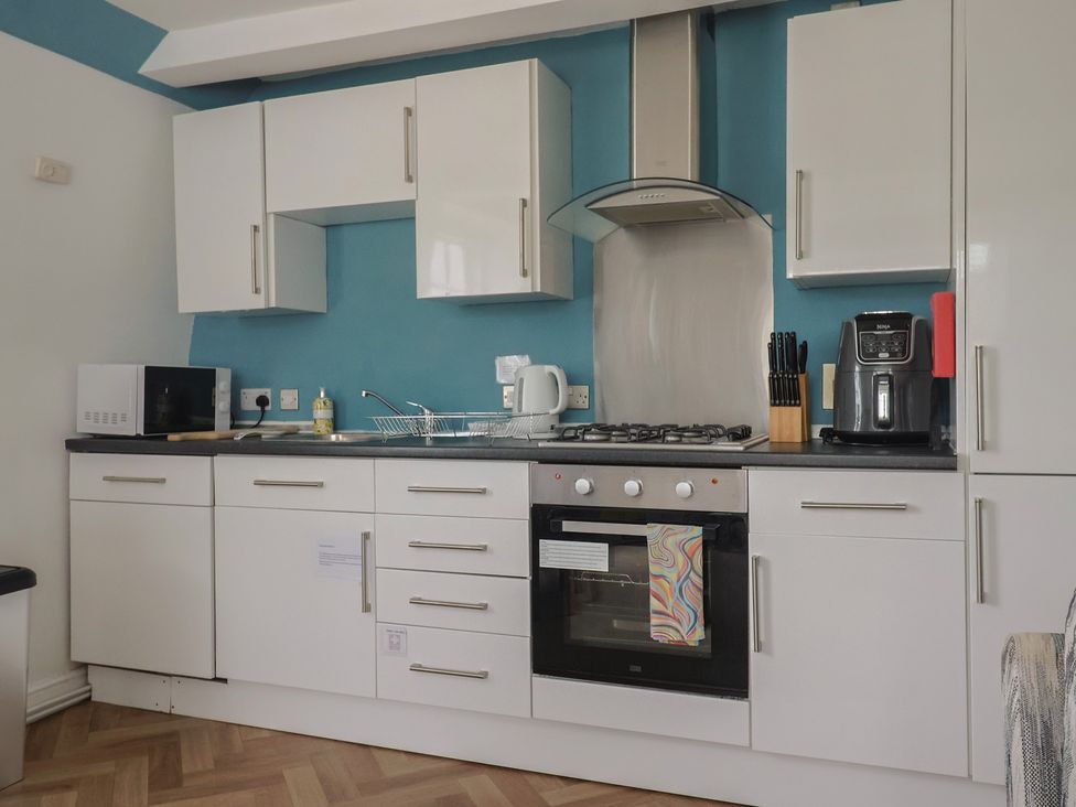 A kitchen with appliances and cabinets at Jasper in Lyme Regis