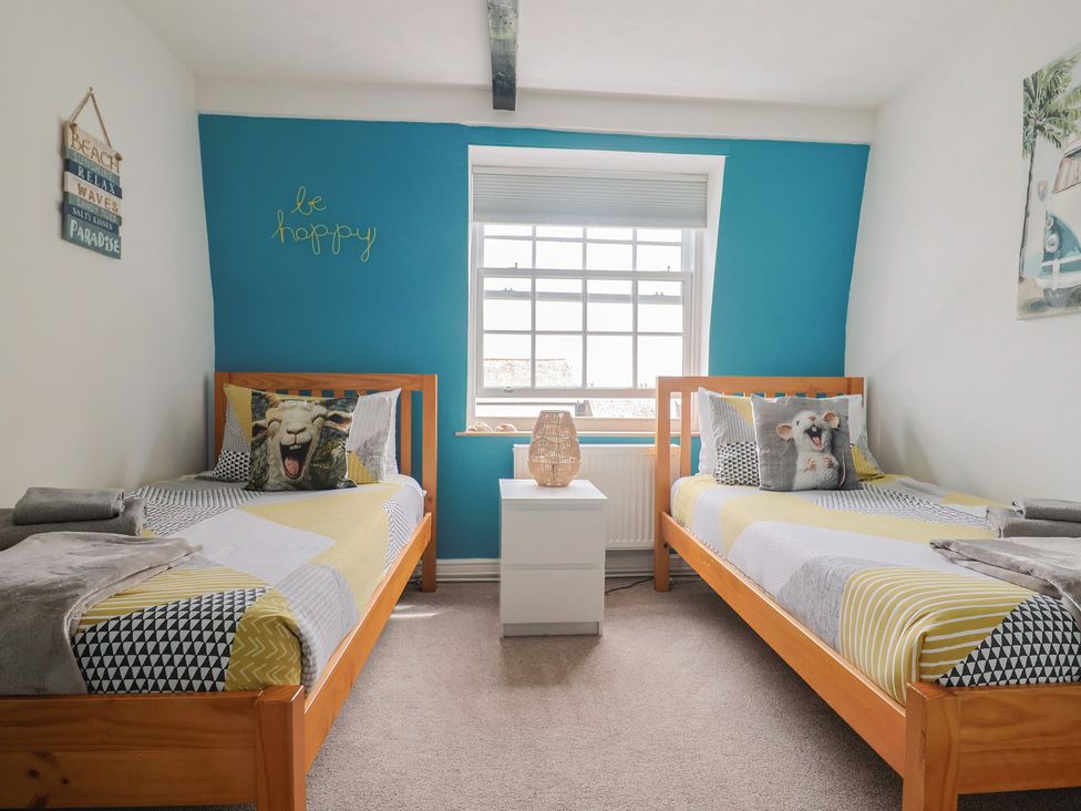 A bedroom with two beds and a window at Jasper in Lyme Regis