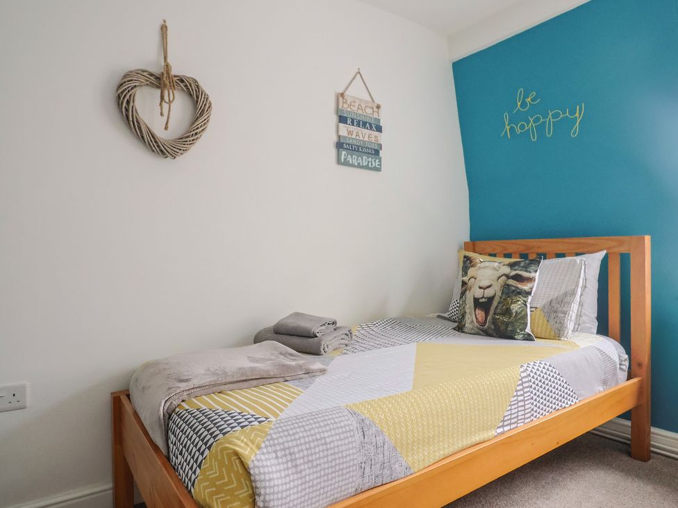 A bedroom with a bed and wall decorations at Jasper in Lyme Regis