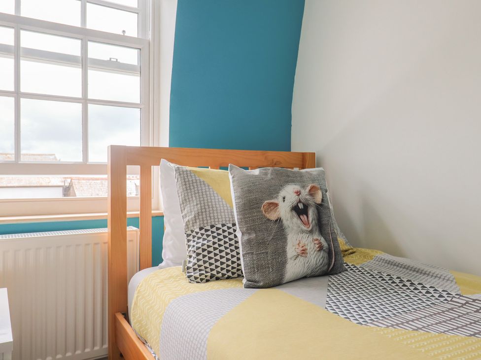 A bedroom with a bed and a pillow at Jasper in Lyme Regis