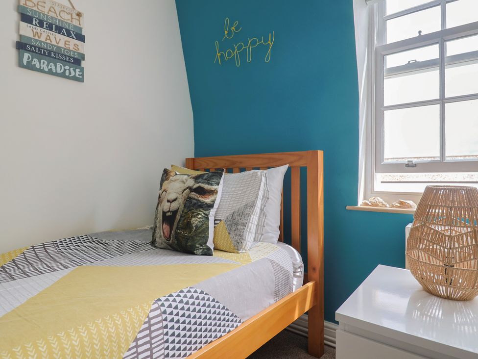 A bedroom with a bed and decorative items at Jasper in Lyme Regis
