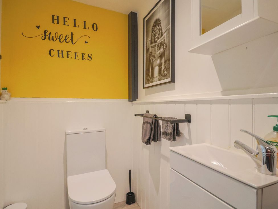 A bathroom with a toilet and sink at Jasper in Lyme Regis