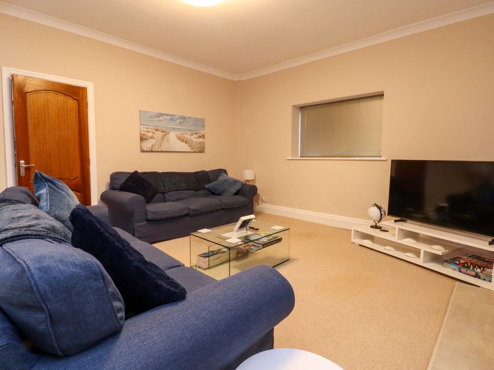 A living room with a television and seating arrangement at 6D Clifton Drive Lytham St. Annes