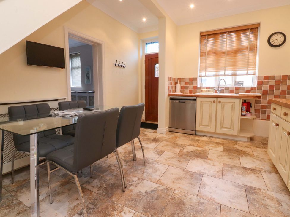 A kitchen with table and chairs and cabinets at 6D Clifton Drive Lytham St. Annes