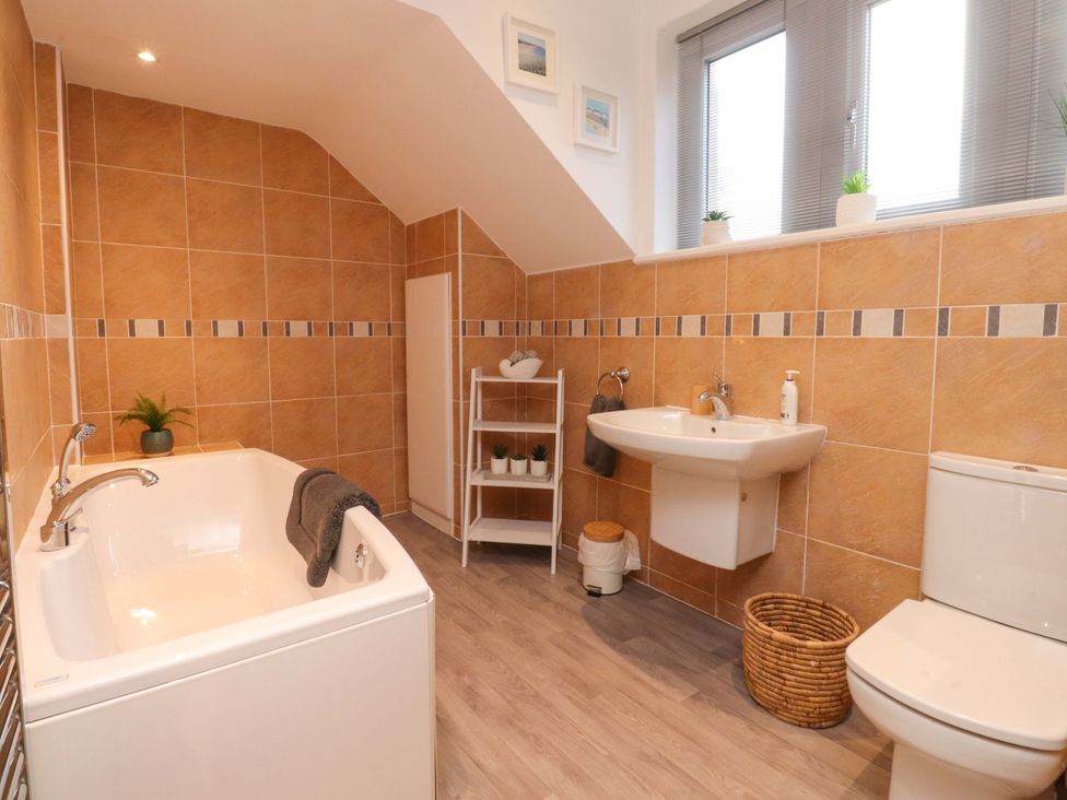 A bathroom with a bathtub, sink, and toilet at 6D Clifton Drive in Lytham St. Annes