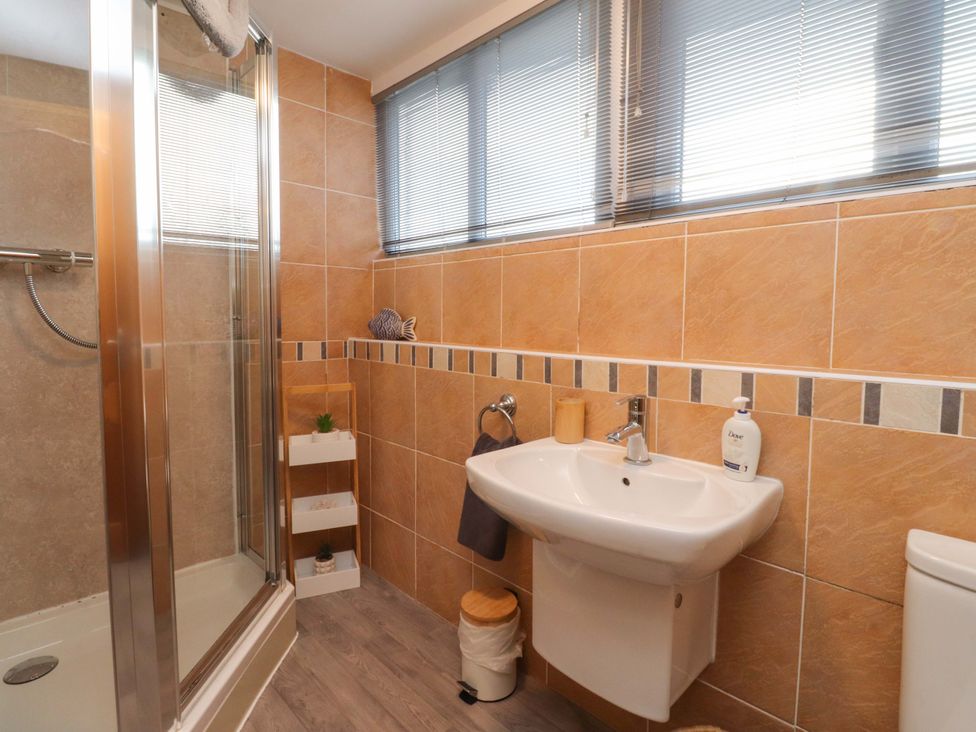 A bathroom featuring a shower, sink, and toilet at 6D Clifton Drive, Lytham St. Annes