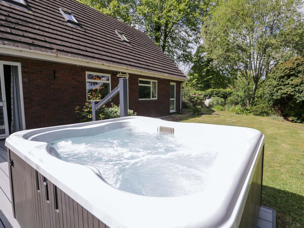 A hot tub in a garden at Woodlands Retreat Llanfwrog near Ruthin