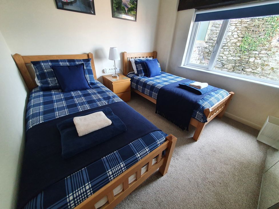 A bedroom with two single beds and a nightstand at Lynmouth View in Lynmouth