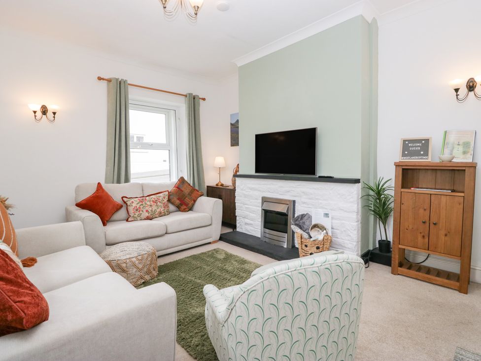 A living room with a sofa and television at 3 Nixon Terrace in Broughton Moor near Maryport