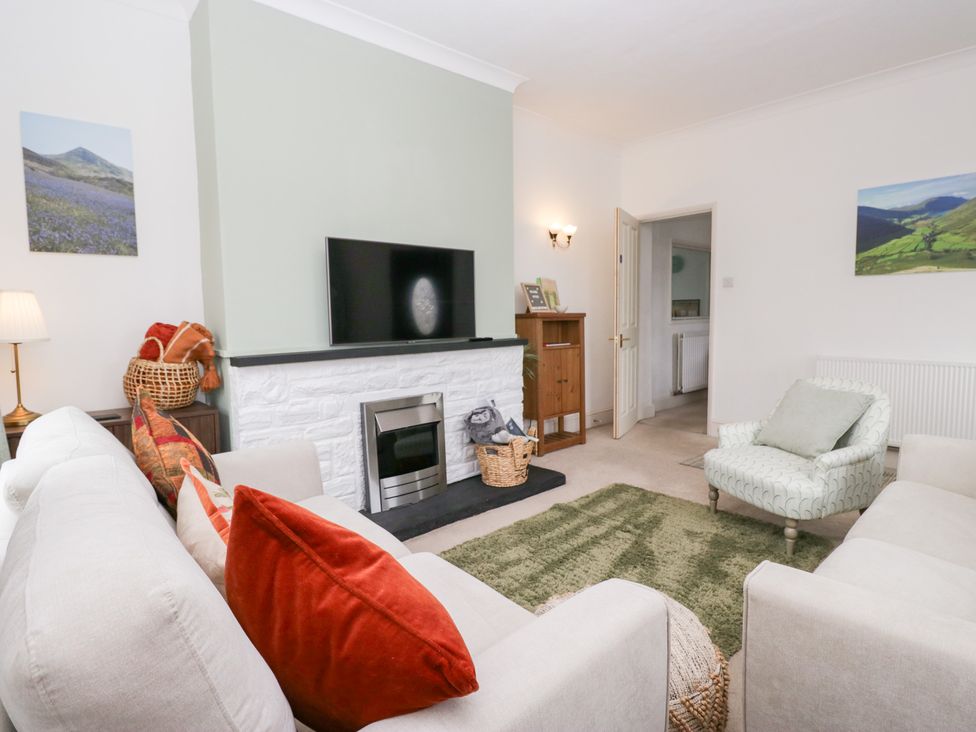 A living room with a sofa and television at 3 Nixon Terrace Broughton Moor near Maryport