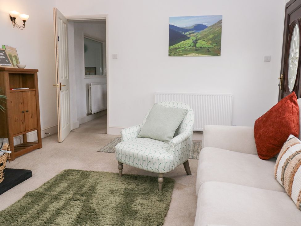 A living room with armchair and sofa at 3 Nixon Terrace Broughton Moor near Maryport
