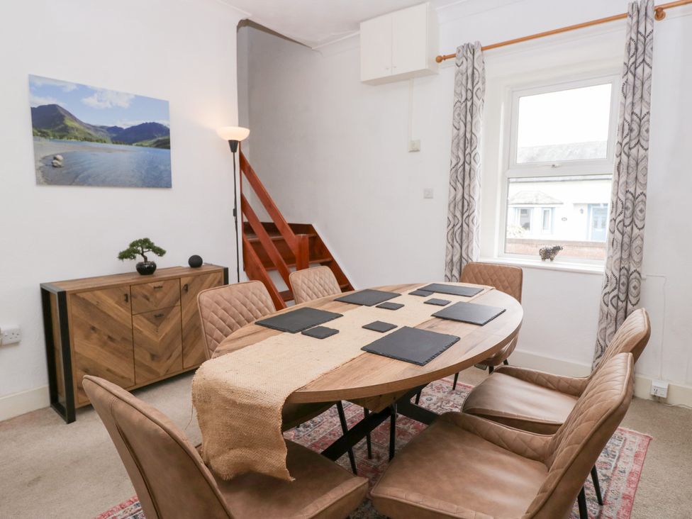 A dining room with a table and chairs at 3 Nixon Terrace near Broughton Moor