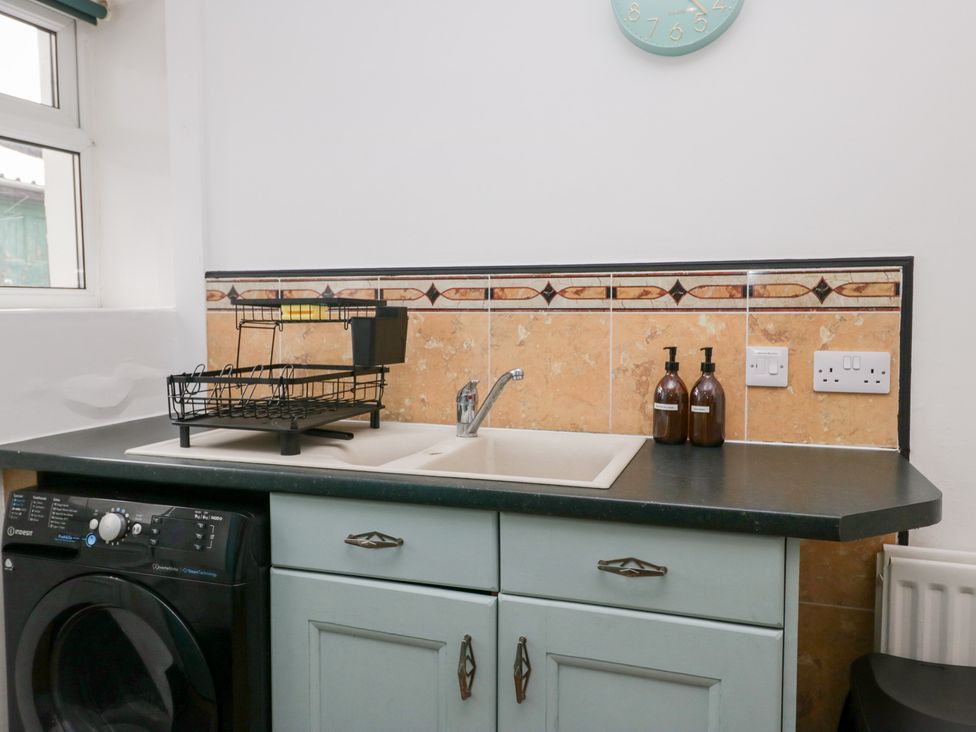 A kitchen with a sink and cabinets at 3 Nixon Terrace in Broughton Moor near Maryport