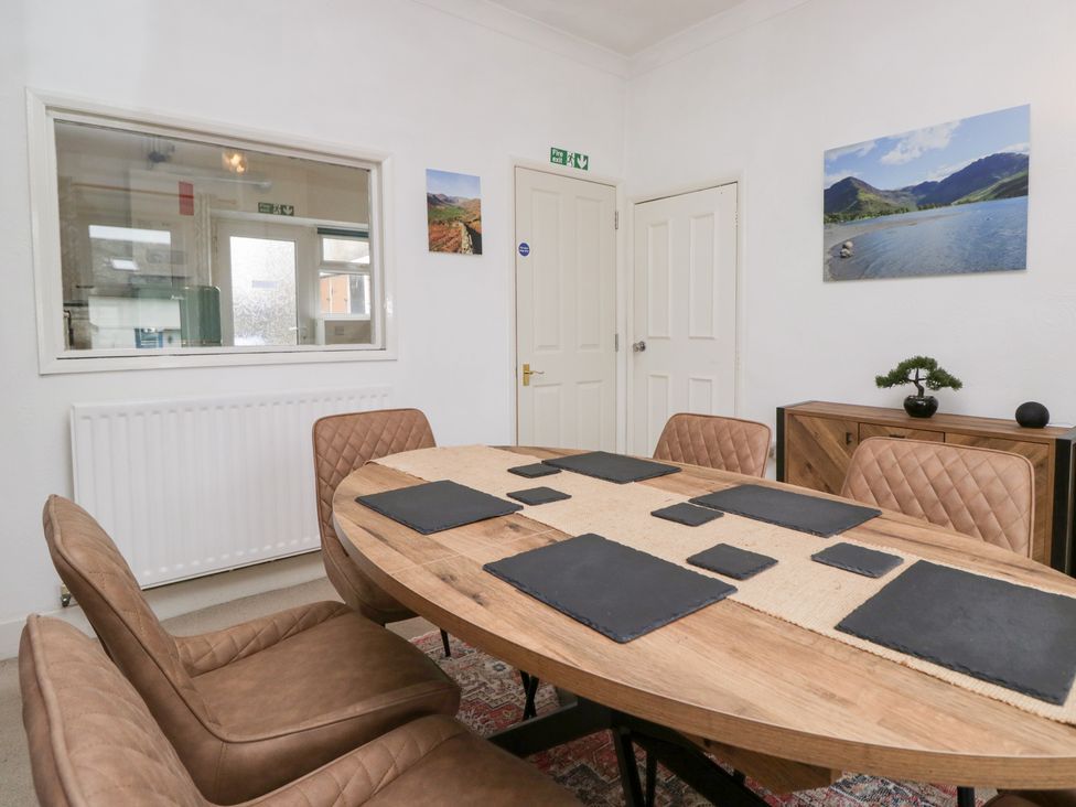 A dining room with a table and chairs at 3 Nixon Terrace Broughton Moor near Maryport