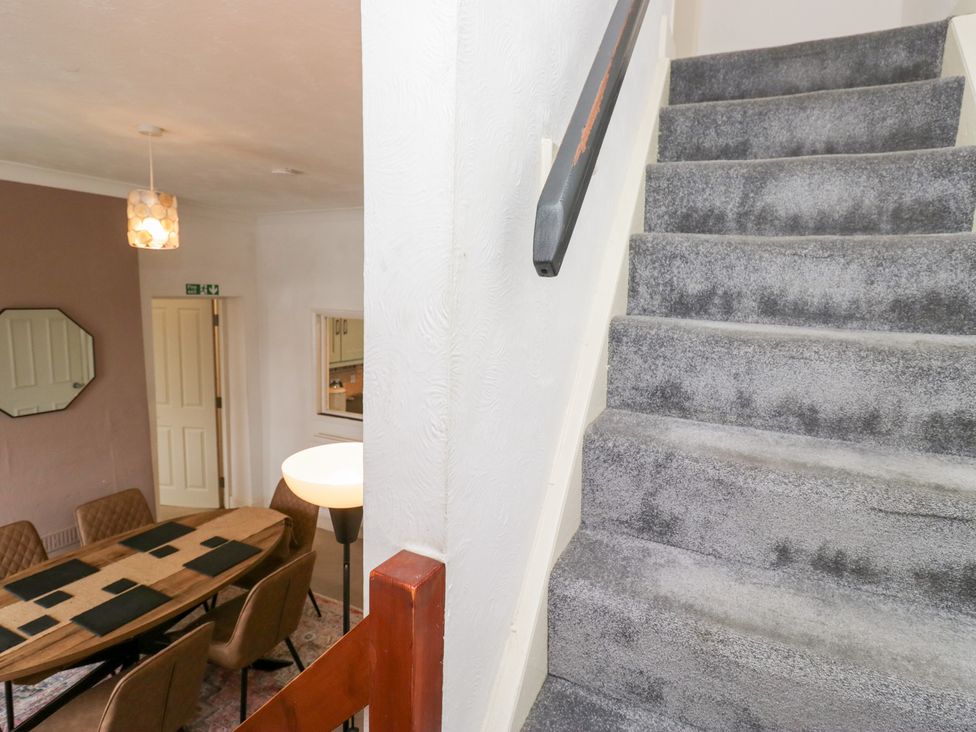 A view of stairs leading to the upper floor and a dining room at 3 Nixon Terrace Broughton Moor near Maryport