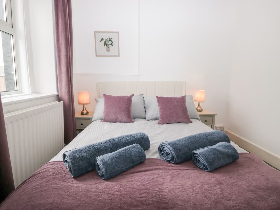 A bedroom with a bed and towels at 3 Nixon Terrace Broughton Moor near Maryport