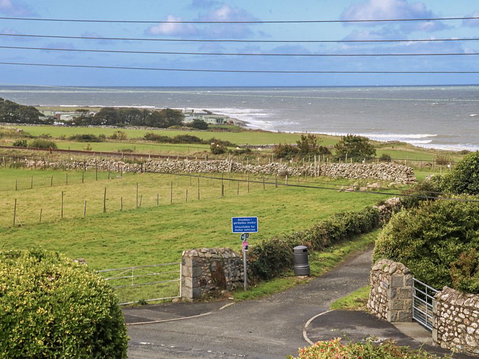 A coastal view with fields and a roadway at Tawelfan in Llwyngwril