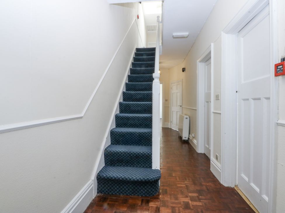 A hallway with stairs and doors at Tawelfan in Llwyngwril