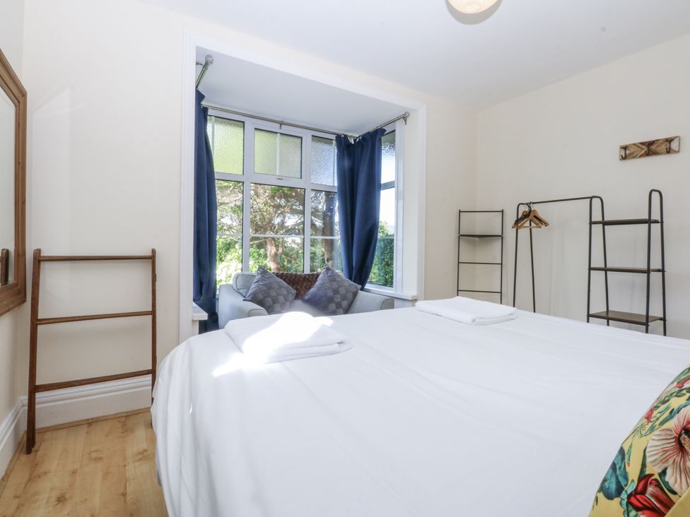 A bedroom with a bed and window at Tawelfan in Llwyngwril