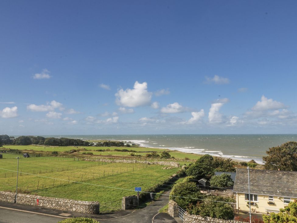 A view of the sea and grass fields at Tawelfan in Llwyngwril