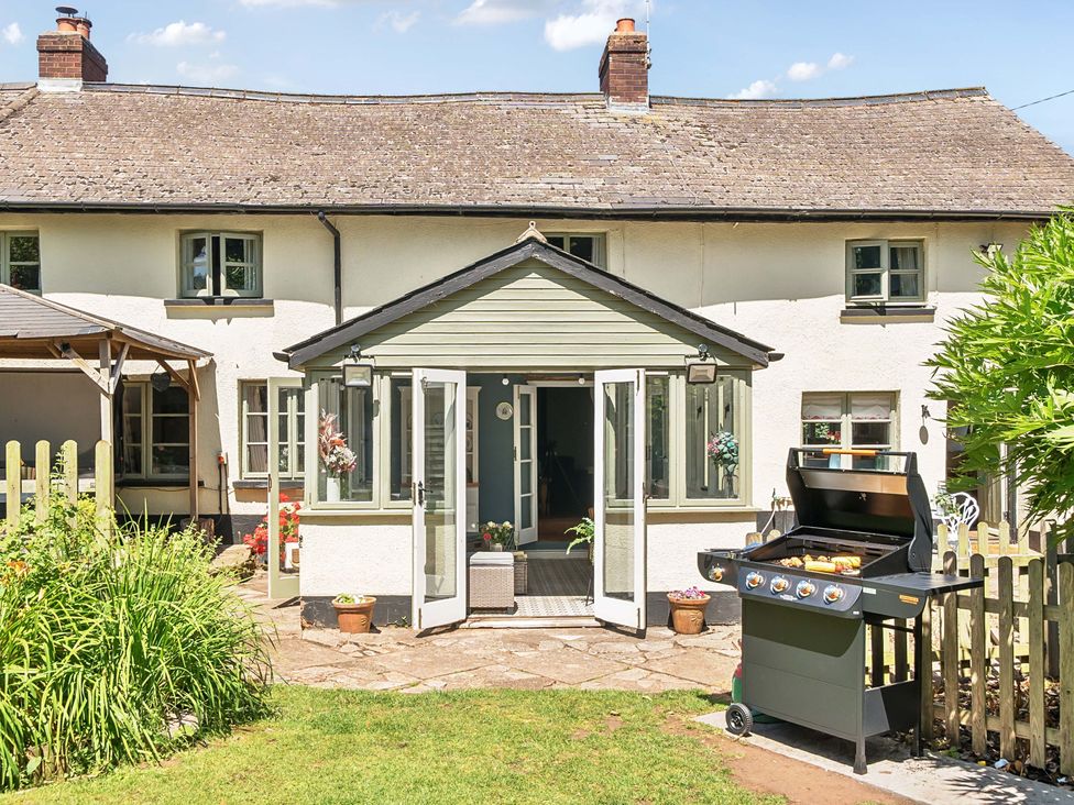 An outdoor patio with a grill at 2 Pigsfoot Cottages in Ash Thomas near Halberton, Devon