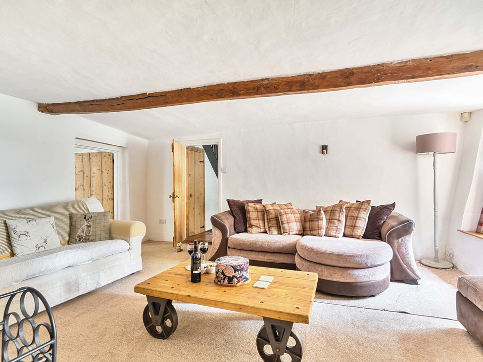 A living room with sofa and coffee table at 2 Pigsfoot Cottages in Ash Thomas near Halberton, Devon