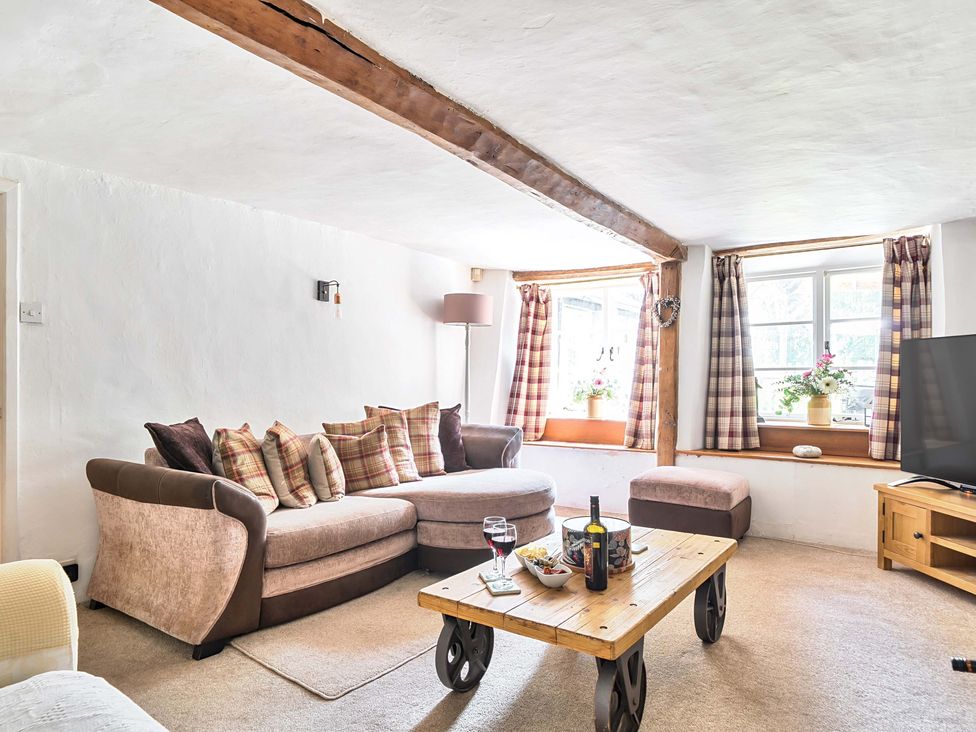 A living room with a sofa and table at 2 Pigsfoot Cottages Ash Thomas near Halberton, Devon