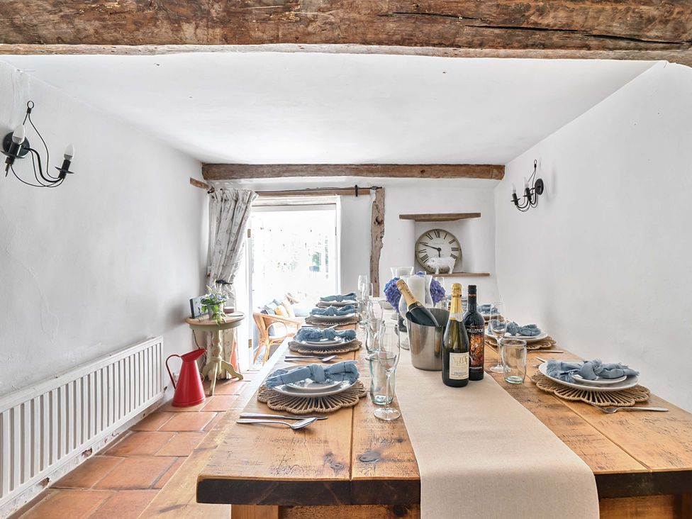 A dining room with a table set for dinner at 2 Pigsfoot Cottages Ash Thomas near Halberton Devon