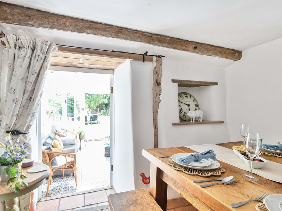 A dining room with a table set for two at 2 Pigsfoot Cottages Ash Thomas near Halberton, Devon