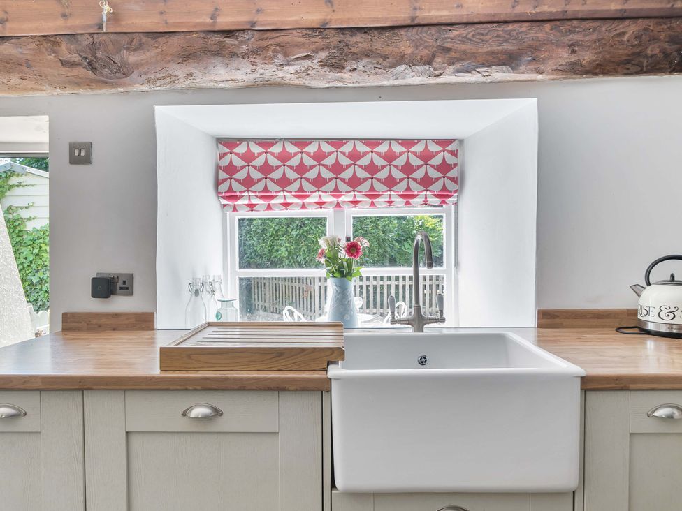 A kitchen with a sink and window at 2 Pigsfoot Cottages Ash Thomas near Halberton, Devon