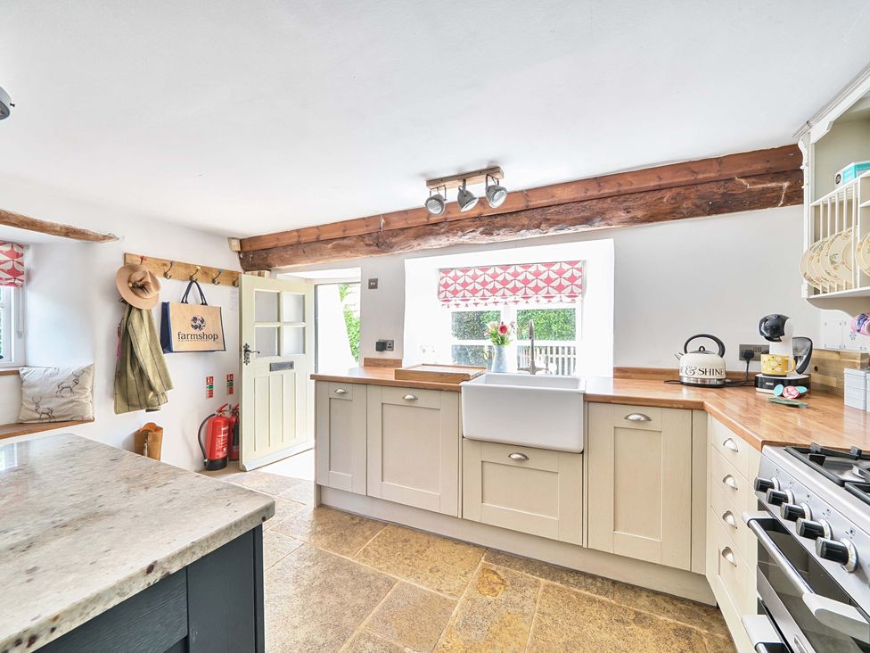 A kitchen with a sink and stove at 2 Pigsfoot Cottages Ash Thomas near Halberton, Devon