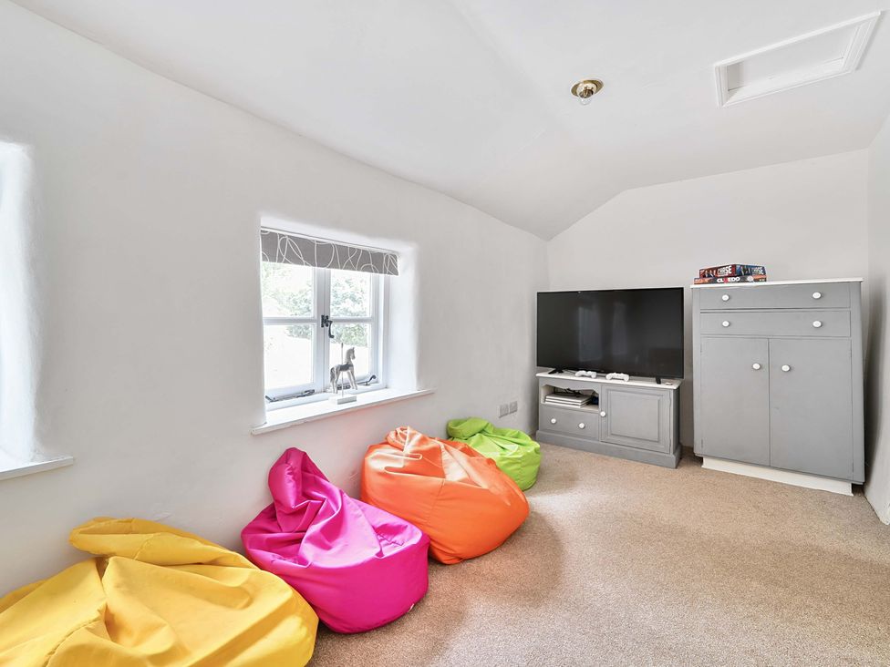 A snug with bean bags and a television at 2 Pigsfoot Cottages Ash Thomas near Halberton, Devon
