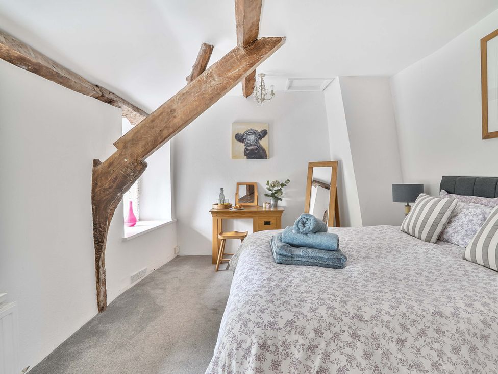 A bedroom with a bed and desk in 2 Pigsfoot Cottages Ash Thomas near Halberton, Devon