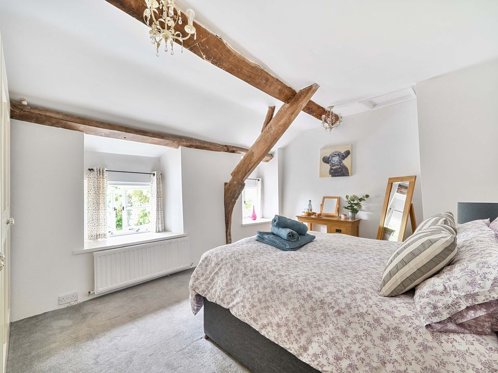A bedroom with a bed and window at 2 Pigsfoot Cottages Ash Thomas near Halberton, Devon