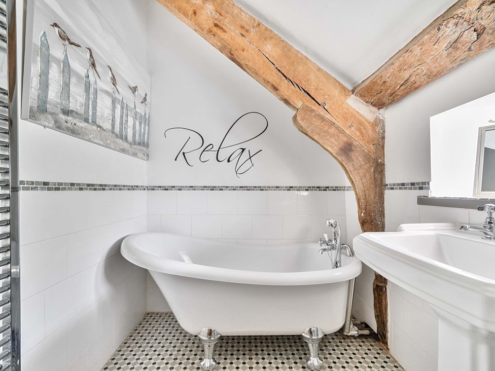 A bathroom with a bathtub and sink at 2 Pigsfoot Cottages Ash Thomas near Halberton, Devon