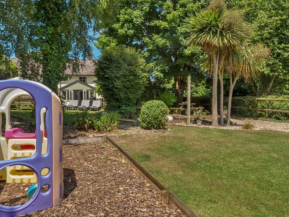 A garden with a playground structure at 2 Pigsfoot Cottages in Ash Thomas near Halberton, Devon