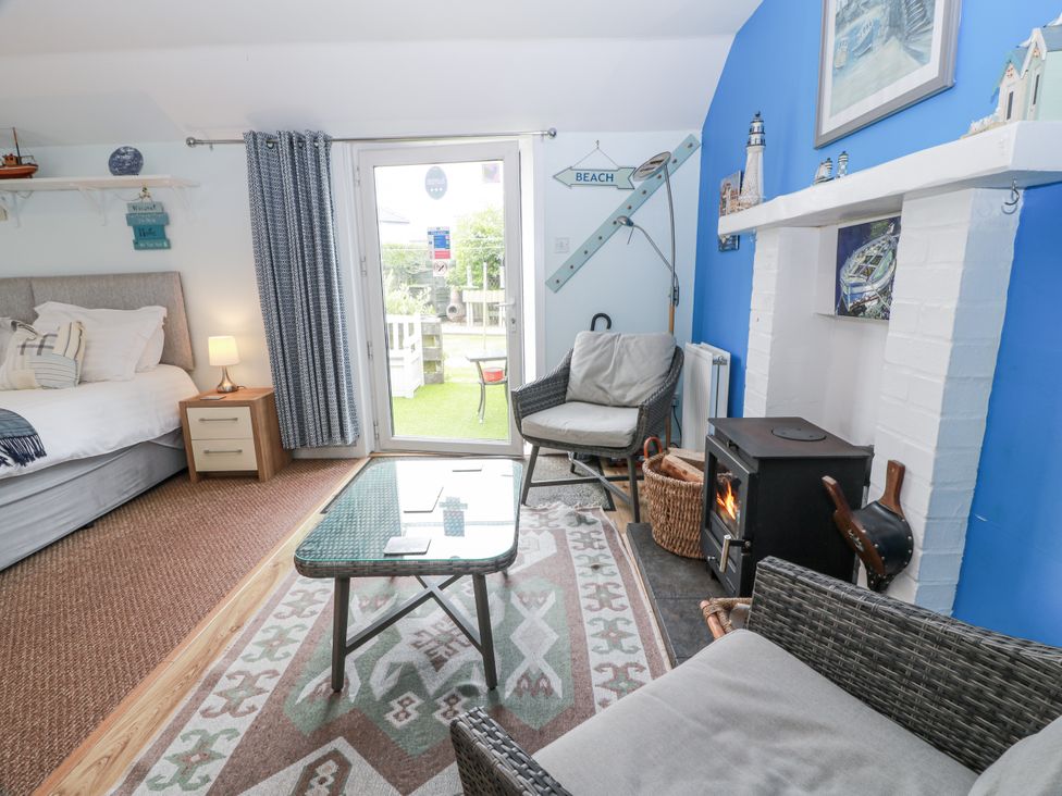A living room with a bed and a coffee table at Learig Cottage in Girvan