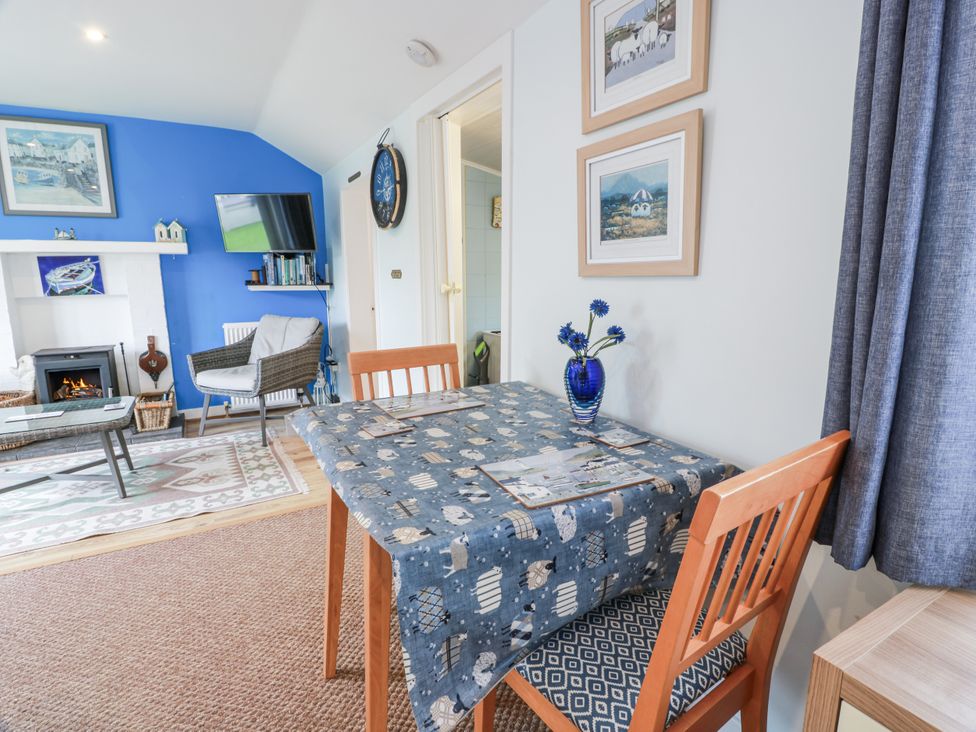 A dining area with a table and chairs at Learig Cottage in Girvan