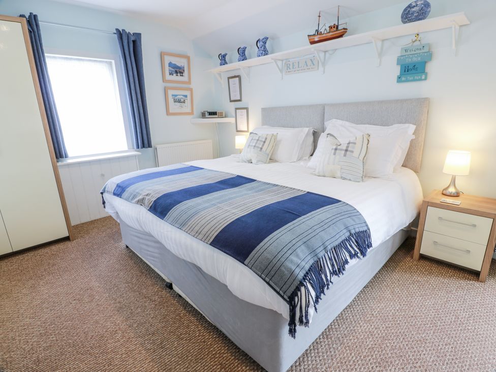 A bedroom with a double bed and a nightstand at Learig Cottage in Girvan