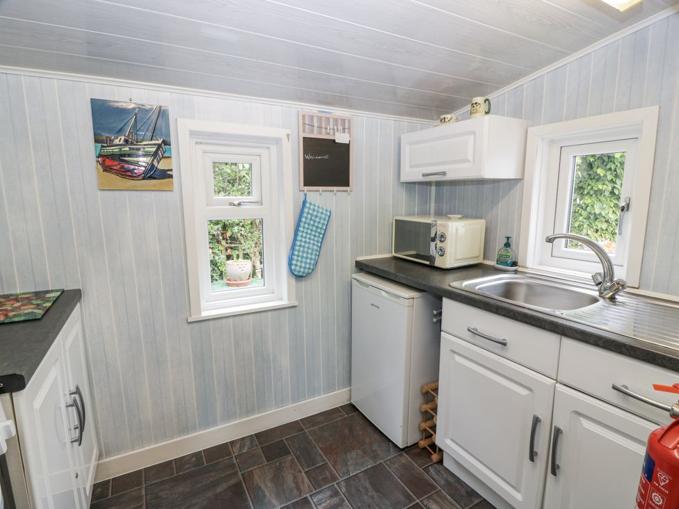 A kitchen with a sink and countertop at Learig Cottage in Girvan
