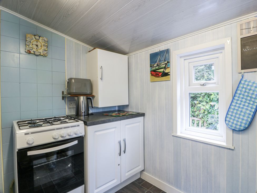 A kitchen with a stove and cabinet at Learig Cottage in Girvan