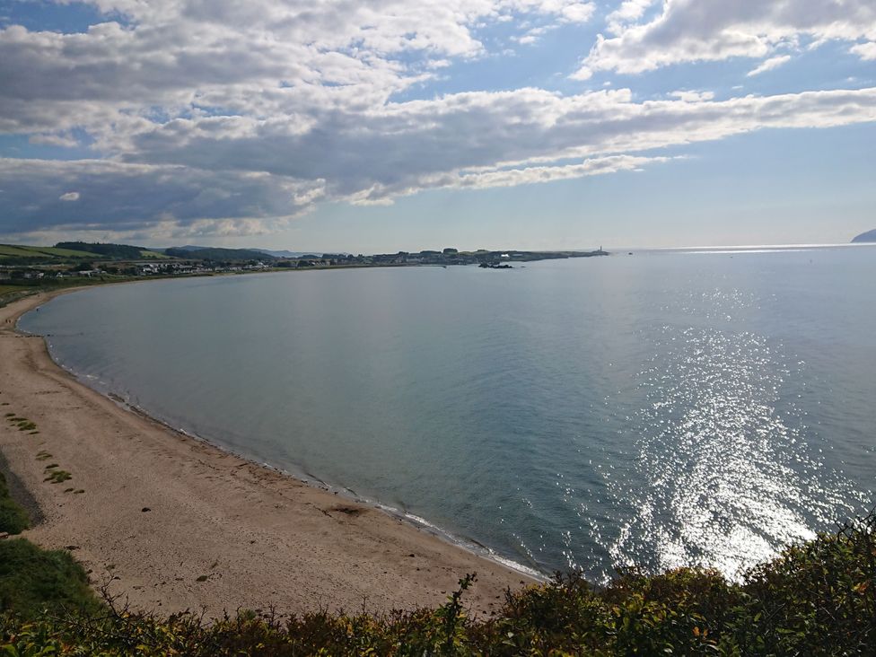 A beach and ocean view with clouds at Learig Cottage in Girvan