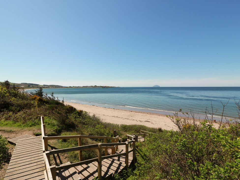 A beach view with a pathway at Learig Lodge in Girvan