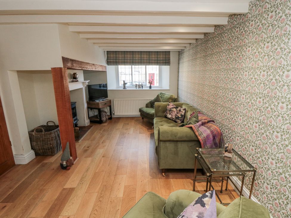 A living room with a sofa and television at Inglenook Cottage in Guisborough