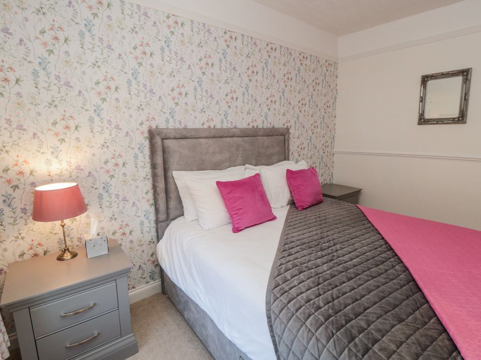 A bedroom with a bed and bedside table at Inglenook Cottage Guisborough