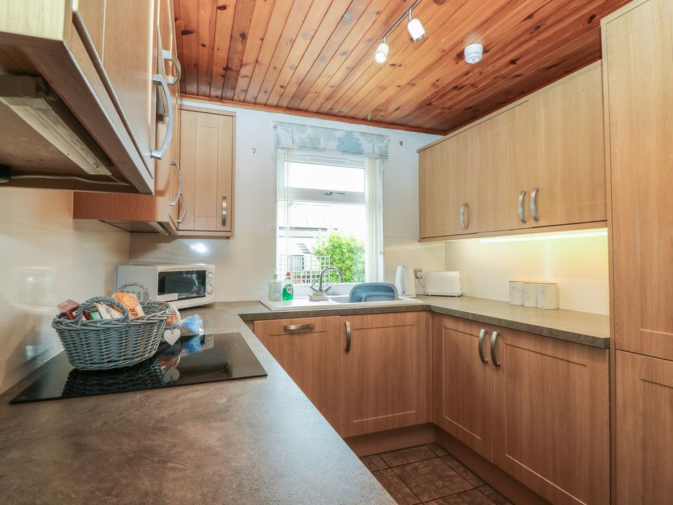A kitchen with cabinets and a sink at Rowan Cottage in Redcastle near Arbroath