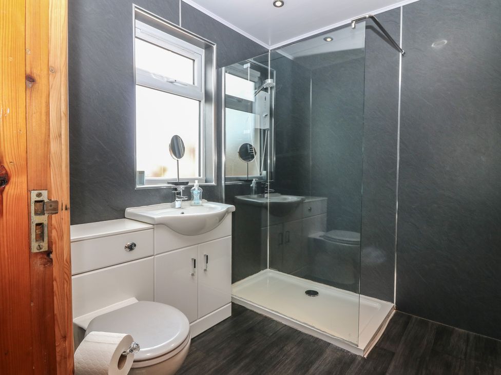 A bathroom with a shower and sink at Rowan Cottage in Redcastle near Arbroath