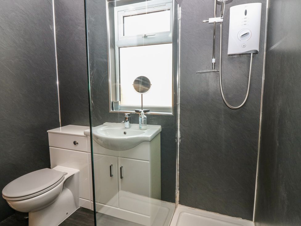 A bathroom with a sink and shower at Rowan Cottage in Redcastle near Arbroath